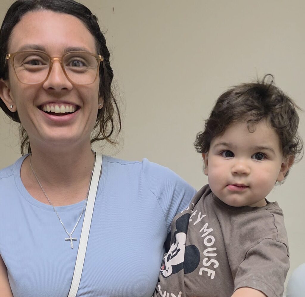 Mother comforting baby after resolving bad latch tongue-tie issue