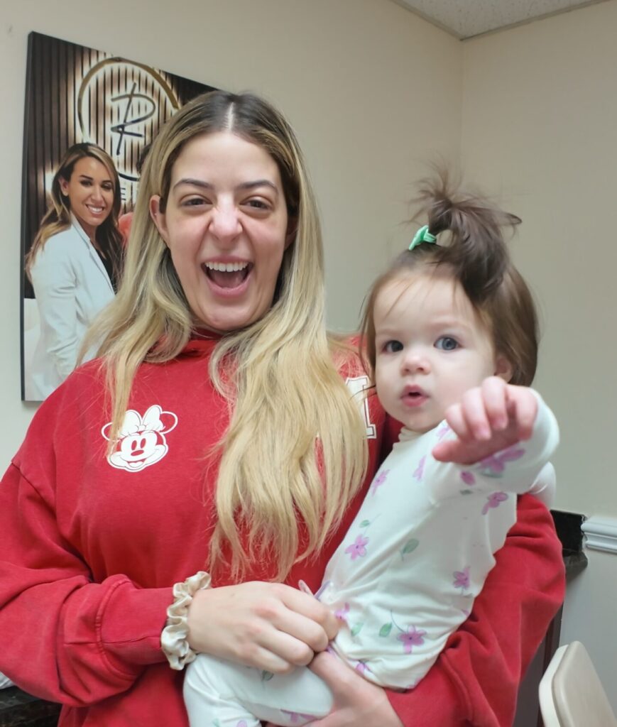 excited mom holding toddler