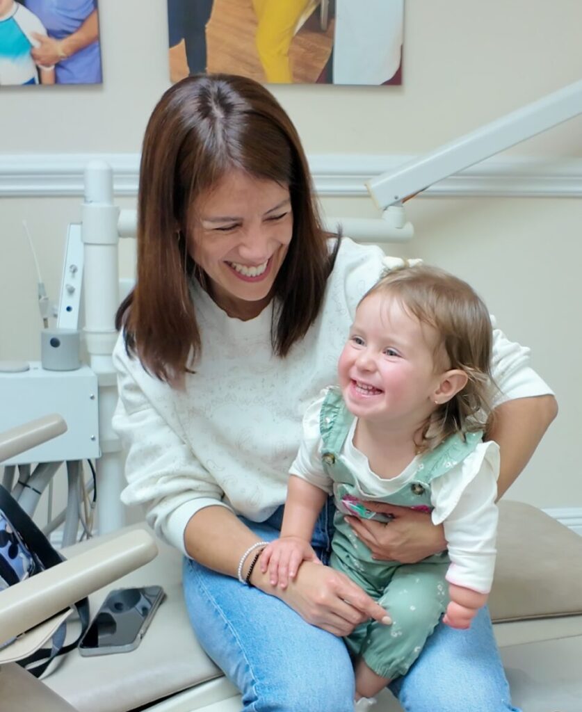mom and toddler laughing together