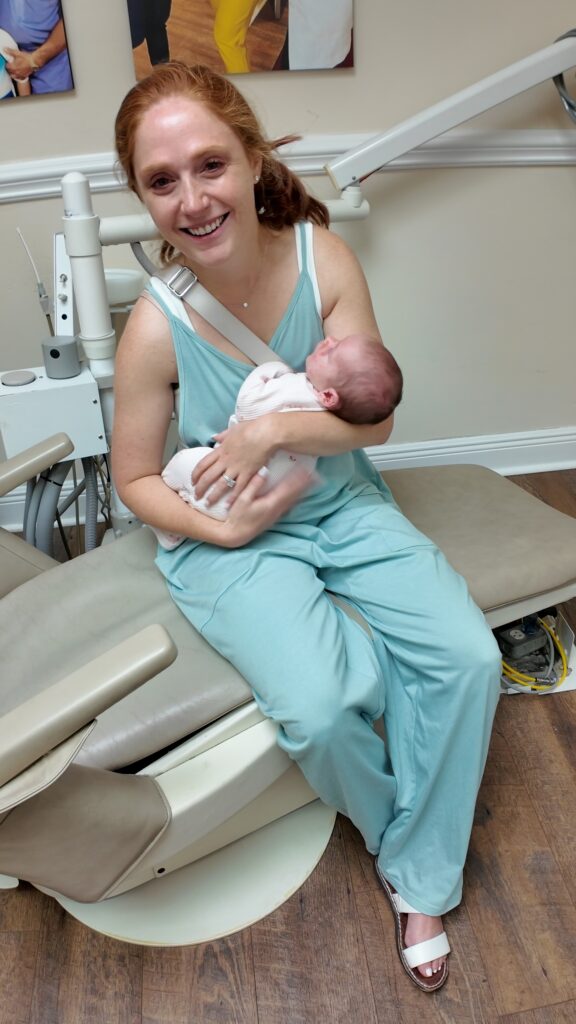 mom holding baby and smiling